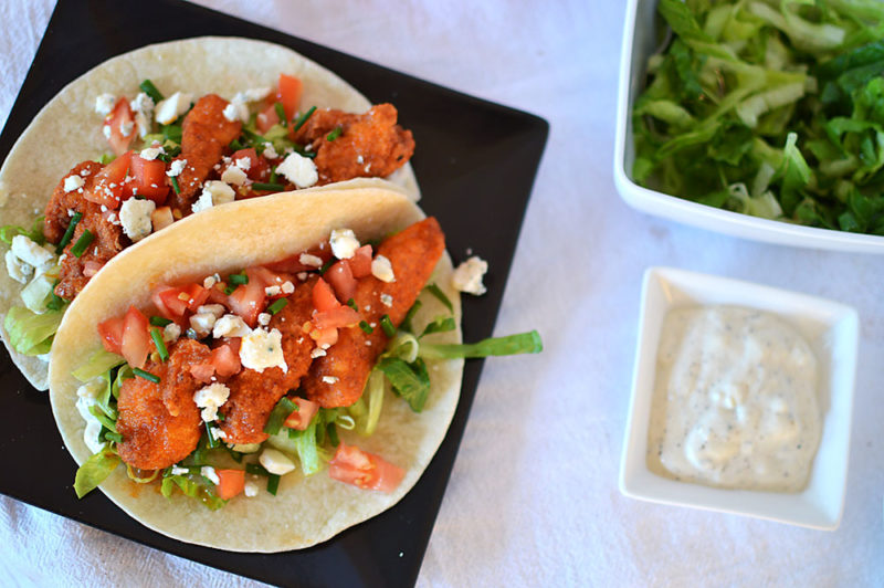 Fried chicken strips coated in spicy buffalo sauce, on a flour tortilla with homemade bleu cheese sauce, tomatoes, lettuce and more bleu cheese.