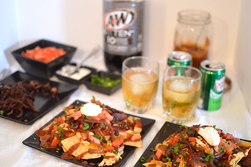 The homemade root beer barbecue sauce is what MAKES this dish! Warm BBQ chicken, cheese, caramelized onions and bacon top these sweet, semi-spicy nachos. Garnish with tomatoes, green onions, and sour cream if you want to max out the flavor! Recipe from thatquareplate.com