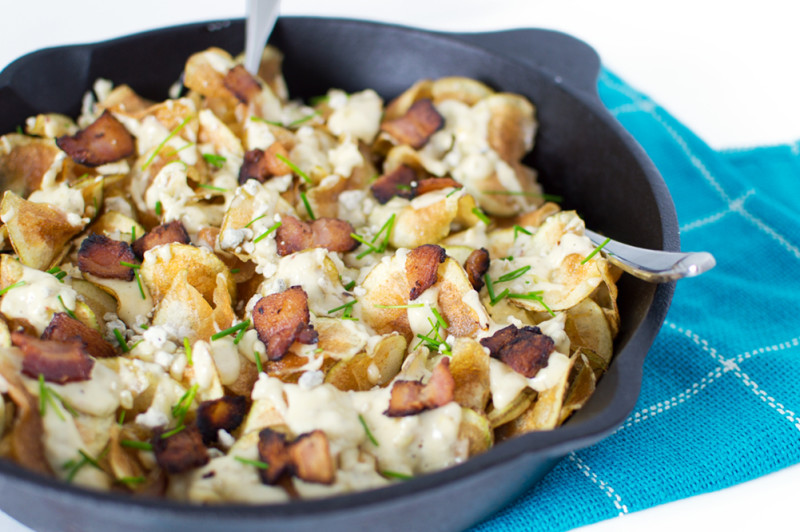 Love these chips when they're fresh from the fryer and topped with the warm gorgonzola cheese sauce, crispy bacon, and fresh chives.