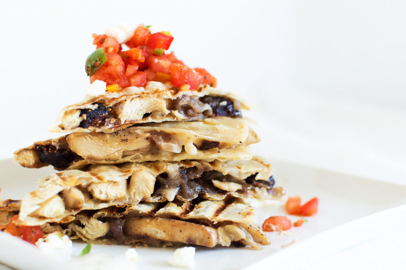 I put a twist on the Mexican style chicken quesadilla and added some Mediterranean flavors! Sliced chicken on a corn tortilla with feta, onions, and figs. Serve with harissa, bell pepper and tomato salsa, and drizzle with an herby sour cream sauce.