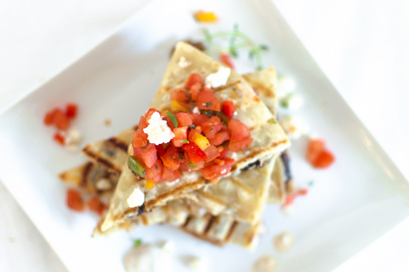 I put a twist on the Mexican style chicken quesadilla and added some Mediterranean flavors! Sliced chicken on a corn tortilla with feta, onions, and figs. Serve with harissa, bell pepper and tomato salsa, and drizzle with an herby sour cream sauce.