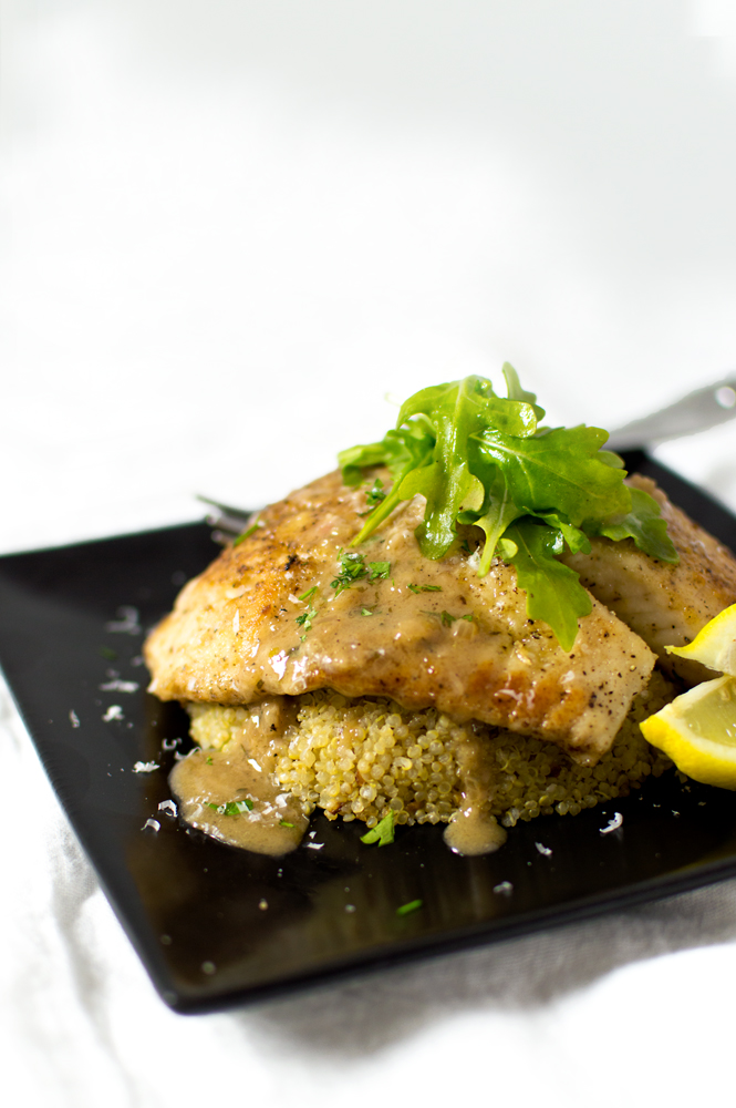 This tilapia is pan-seared and finished in the oven, then topped with a lemony-white wine sauce. I served over serrano-garlic quinoa.