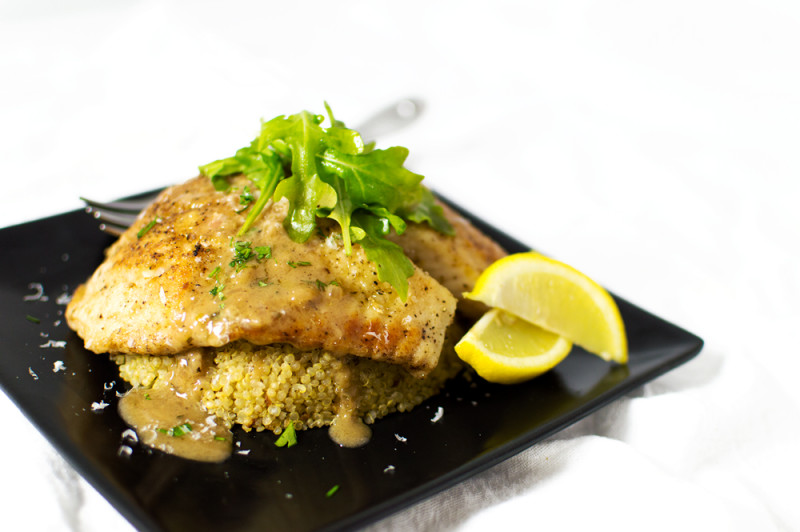 This tilapia is pan-seared and finished in the oven, then topped with a lemony-white wine sauce. I served over serrano-garlic quinoa.