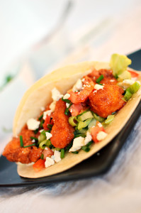 Fried chicken strips coated in spicy buffalo sauce, on a flour tortilla with homemade bleu cheese sauce, tomatoes, lettuce and more bleu cheese.