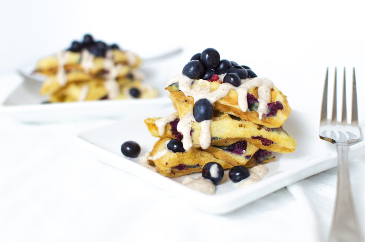 Who wouldn't want to wake up to these fluffy blueberry waffles?! Drizzle the frosting when they're still super-hot, and enjoy with more fresh blueberries.